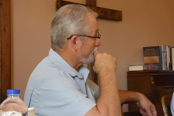 An attendee listening during a synod session